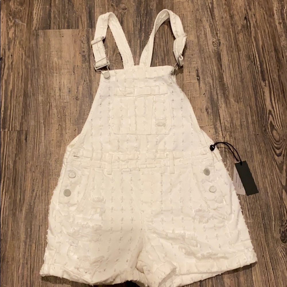 White, distressed overalls